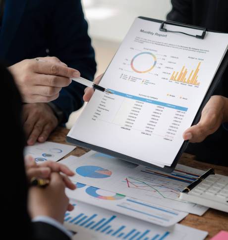 The sales department is having a monthly summary meeting to bring it to the department manager, they are verifying the correctness of the documents that are prepared before bringing in to the manager